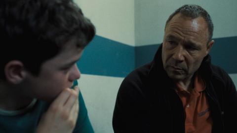 Owen Cooper and Stephen Graham in a police waiting room looking pensive