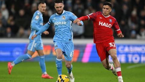 Matt Grimes of Coventry City challenges Marcelino Nunez of Ipswich Town