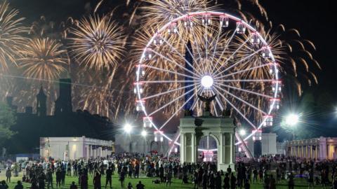 People watch a fireworks display that is attempting the largest firework display in history with 850,000 fireworks 