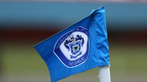 A blue corner flag with the Rochdale AFC badge on it