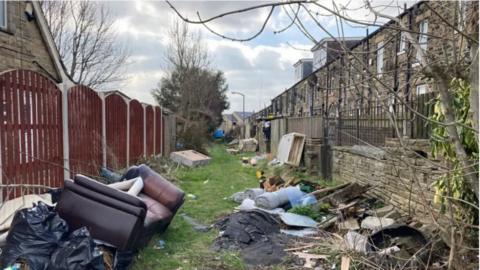 Fly tipping in an alleyway in Bradford