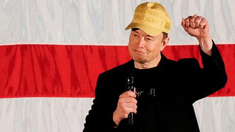 Tesla CEO and X owner Elon Musk, who supports Republican presidential nominee former U.S. President Donald Trump, gestures as he speaks about voting during an America PAC Town Hall in Folsom, Pennsylvania, U.S., October 17, 2024.