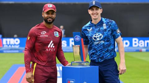 West Indies captain Shai Hope (left) and England captain Harry Brook (right) pose either side of the one-day series trophy