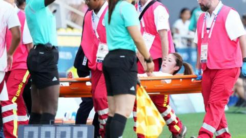 Risa Shimizu is stretchered off injured while playing for Japan