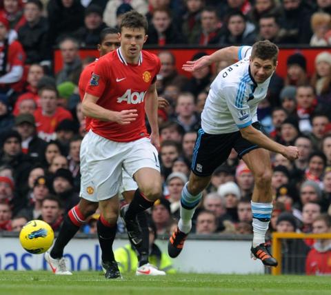 Michael Carrick and Steven Gerrard during a game between Manchester United and Liverpool in 2012