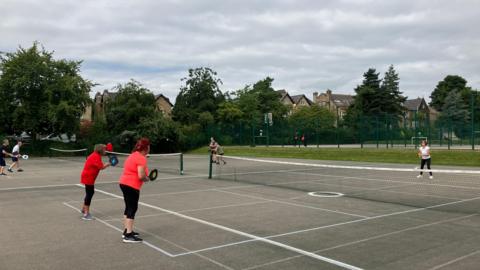 People pictured playing pickleball