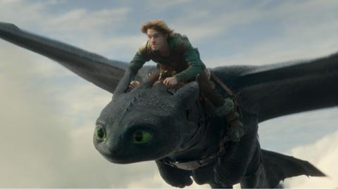 Boy riding a dragon