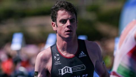 Jonny Brownlee head and torso shot running in GB blue triathlon vest