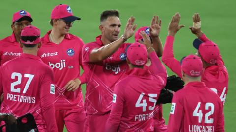 Hardus Viljoen of Paarl Royals and Bjorn Fortuin of Paarl Royals are congratulated for getting the wicket of Matthew De Villiers of Joburg Super Kings during the eliminator match