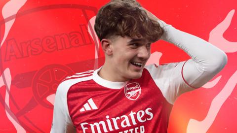 Max Dowman in front of a red background with Arsenal logo. 
