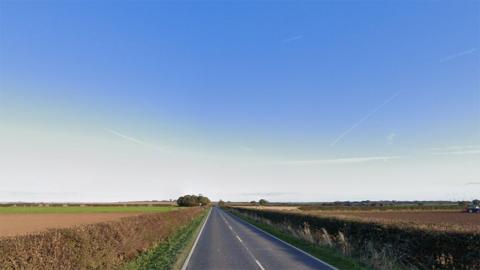 Google street view of the stretch of the A1077 between South Ferriby and Barton-upon-Humber showing a two-lane country road with hedges and fields on both sides