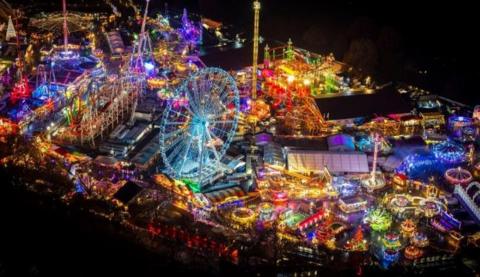 Winter Wonderland in Hyde Park - a fairground with lots of rides is lit up at night