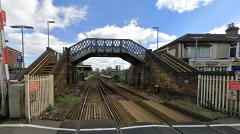 Google Street View looking down the tracks at Cosham Rail Station from the railway level crossing