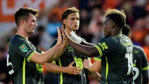 Tanto Olaofe of Lincoln City (R) celebrates scoring the opening goal at Blackpool with team-mate Josh Honohan