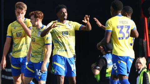 Kyreece Lisbie celebrates with his Colchester team-mates