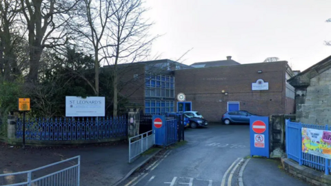 School building with the sign St Leonard's and blue gates