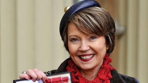 Lady Catherine Meyer holds her Commander of the British Empire (CBE) medal after a ceremony at Buckingham Palace in 2013