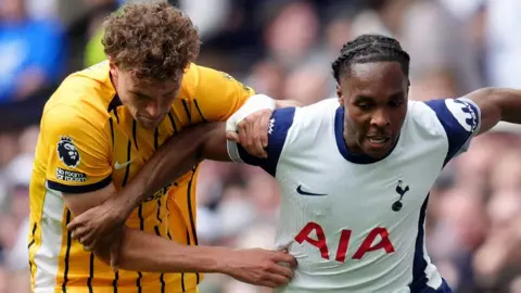 Brighton and Hove Albion's Mats Wieffer (left) and Tottenham Hotspur's Mathys Tel battle for the ball during the Premier League match at the Tottenham Hotspur Stadium