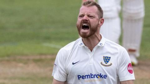 Nathan McAndrew celebrates claiming a wicket