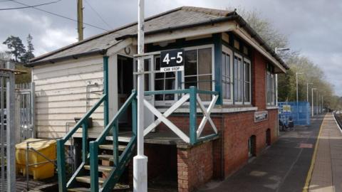 A brick building next to a railway platform