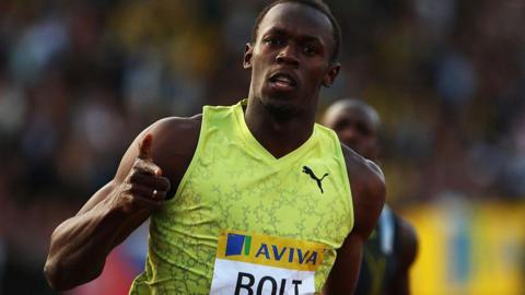 Usain Bolt points at the camera after finishing a race at Crystal Palace athletics stadium in 2009.