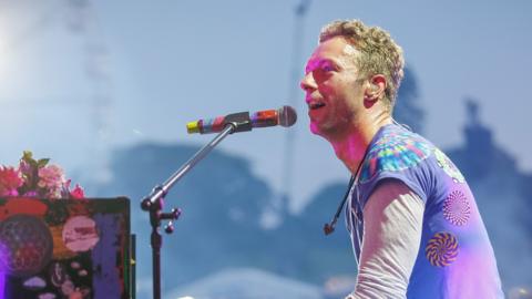 Lead singer of Coldplay (Chris Martin) performing on stage at Radio 1's Big Weekend. 