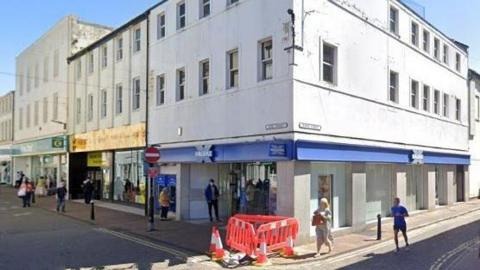 A Google Streetview screenshot of the former Halifax bank on the corner of King Street and Roper Street in Whitehaven.