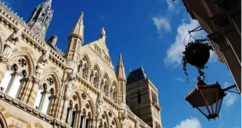 A view of the exterior of the upper floors of Northampton Guildhall on a sunny day.