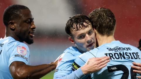 Doncaster Rovers players hug