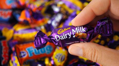 Cadbury's Dairy Milk Mini being held up