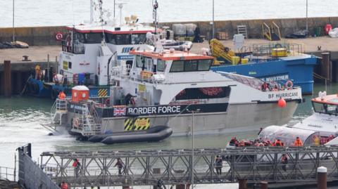 Groups of people being brought in to Dover, Kent, on board Border Force vessels on 4 October 