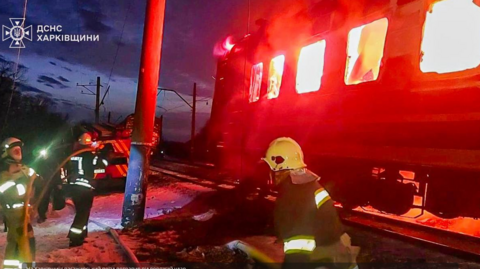 A photo released by Ukraine's DSNS emergency service show its employees tackle a fire as a carriage of a passenger train burns after a Russian drone attack in Ukraine's north-eastern Kharkiv region. Photo: 27 January 2026