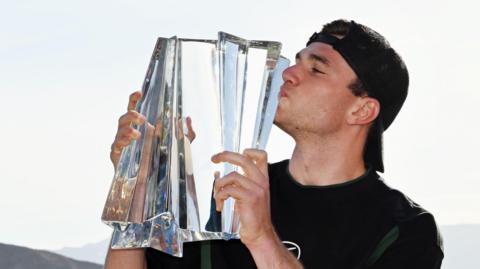 Jack Draper celebrates with the Indian Wells trophy