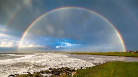 Adouble rainbow over the sea and fairways at Machrihanish golf course