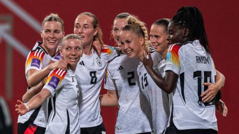 Germany celebrate scoring during their European Championship qualifier against Poland