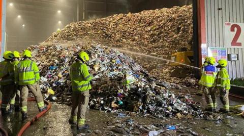 Firefighters at the scene of the fire at a recycling centre