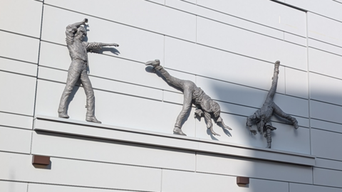 The artwork of the Cartwheeling Boys in Reading on a wall.