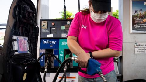 A woman refuels their motorcycle at a Bangchak Corporation Public Company Limited station in Bangkok, Thailand, on March 26, 2026