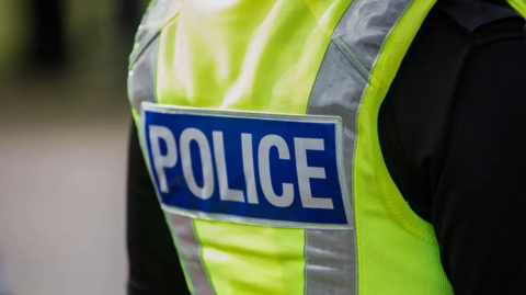 A photo of a high-visibility police vest.