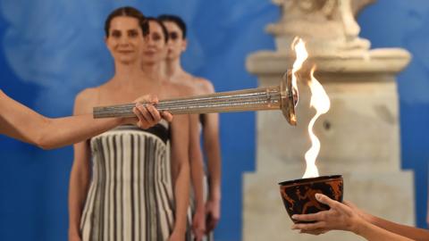 Olympic torch being lit.