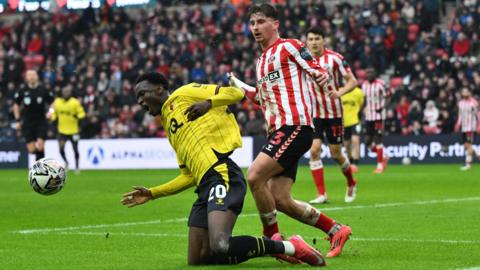 Sunderland defender Dennis Cirkin fouls Watford striker Mamadou Doumbia for a penalty