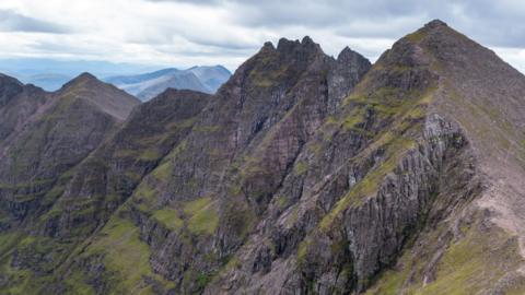 A steep, rocky ridge with areas of loose rocks called scree.