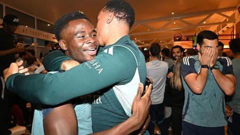 Arsenal players celebrate the title win.