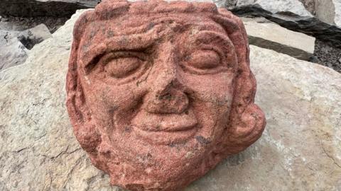 A carved sandstone face in close-up