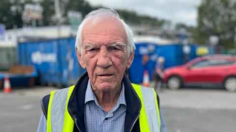 Devon County Council cabinet member Roger Croad in a hi-vis gilet at Totnes Recycling Centre