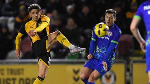 Harrison Biggins of Newport County has a shot at goal