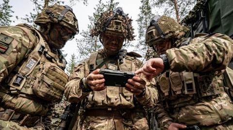  British Army 3 Rifles soldiers use a phone-sized electronic screen display, which forms part of the Android Team Awareness Kit (ATAK), at an undisclosed training ground less than 50 kilometres from the Russian border in Finland where Nato troops are taking part in Exercise Northern Star, led by the Finnish military.