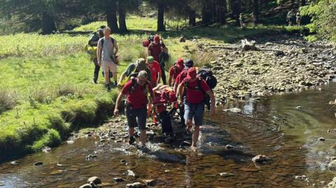 Glossop Mountain Rescue Team taking injured walker to safety