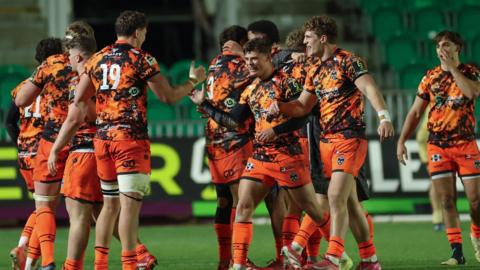 Dragons players celebrating their late win.