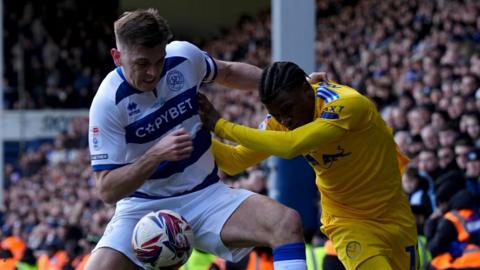 Queens Park Rangers' Jimmy Dunne (left) and Leeds United's Largie Ramazani battle for the ball 